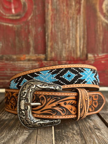 Tan tooled leather with an Aztec bead inlay in black, light blue, tan, and brown, finished with an etched buckle — a bold, color-forward western belt with a cool-toned palette that brings artisan craftsmanship and southwestern character to any outfit.