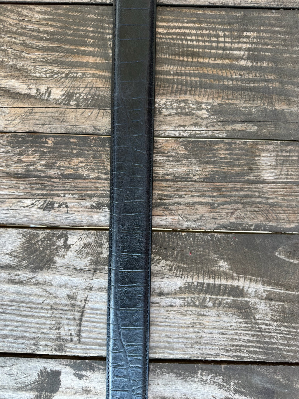 Black leather with deep caiman print scaling and a clean tapered tip — bold exotic texture with a sleek, all-black finish. A statement belt that pairs with virtually anything in your western wardrobe.