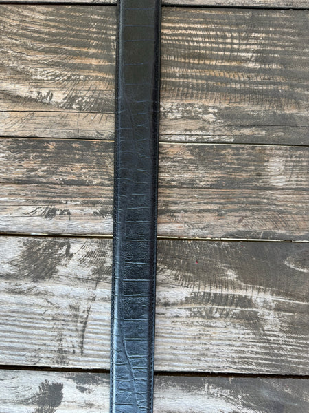Black leather with deep caiman print scaling and a clean tapered tip — bold exotic texture with a sleek, all-black finish. A statement belt that pairs with virtually anything in your western wardrobe.