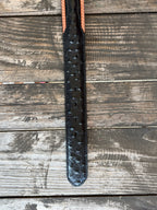 Black ostrich print leather with tan leather trim edges and cream contrast stitching, finished with a large engraved silver western buckle — an exotic, eye-catching belt with refined western character. Find it at Blair's Western Wear in Marble Falls, TX or online at blairswesternwear.com.