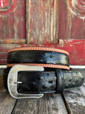 Black ostrich print leather with tan leather trim edges and cream contrast stitching, finished with a large engraved silver western buckle — an exotic, eye-catching belt with refined western character. Find it at Blair's Western Wear in Marble Falls, TX or online at blairswesternwear.com.