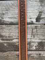 Dark chocolate ostrich print leather with a tan leather trim edge and cream contrast stitching, finished with an engraved silver western buckle — a refined, two-tone exotic belt with the kind of texture and detail that elevates any western outfit.