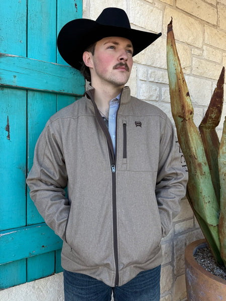Men’s CINCH bonded zip jacket in tan with chocolate accents, weather-resistant shell, soft printed lining, and adjustable cuffs – MWJ1567014. Available at Blair’s Western Wear, Marble Falls, TX.
