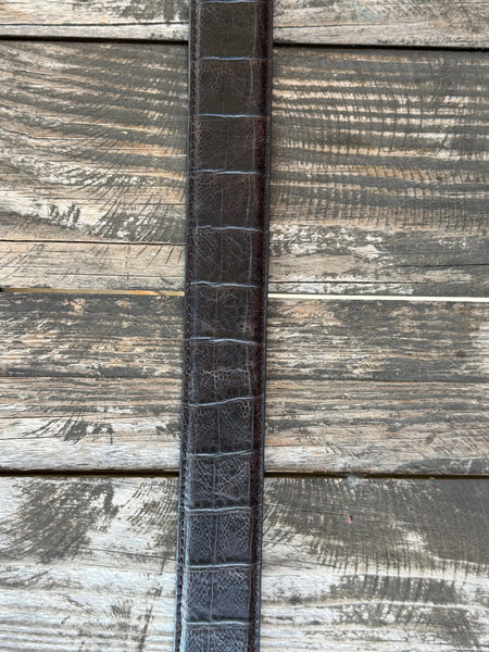 Rich chocolate caiman print leather with a clean tapered profile and a large engraved silver western buckle with rope edge detail — bold exotic texture with a warm, earthy finish that pairs with virtually anything in your western wardrobe.