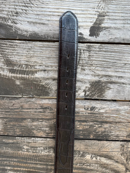Rich chocolate caiman print leather with a clean tapered profile and a large engraved silver western buckle with rope edge detail — bold exotic texture with a warm, earthy finish that pairs with virtually anything in your western wardrobe.