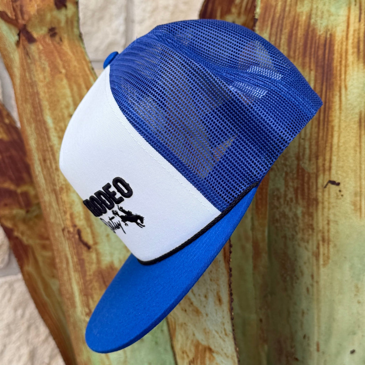 A blue and white trucker hat with a white front panel and blue mesh back