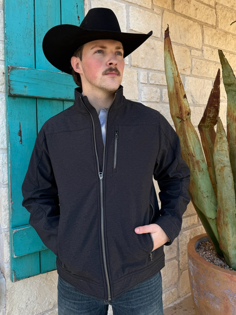 Men’s Cinch bonded concealed carry jacket in black, made from wind-resistant softshell with fleece lining, featuring concealed carry pockets and full-zip front – MWJ1539006. Available at Blair’s Western Wear, Marble Falls, TX.