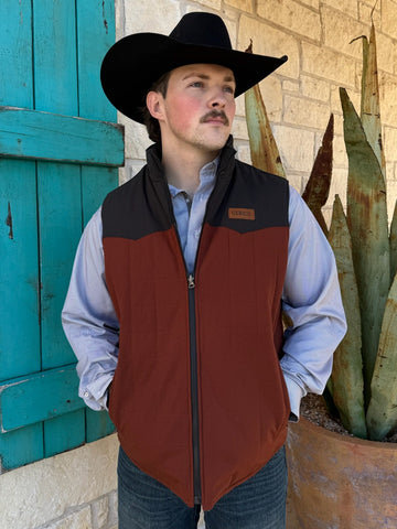 Men’s Cinch reversible canvas vest in rust and black, made from wax-coated fabric for weather resistance, with quilted insulation and zip pockets – MWV1576005. Available at Blair’s Western Wear, Marble Falls, TX.