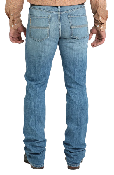 Men's slim fit stretch denim jean in medium stonewash with sanding and whisker details and boot-friendly leg opening — Blair's Western Wear Marble Falls TX
