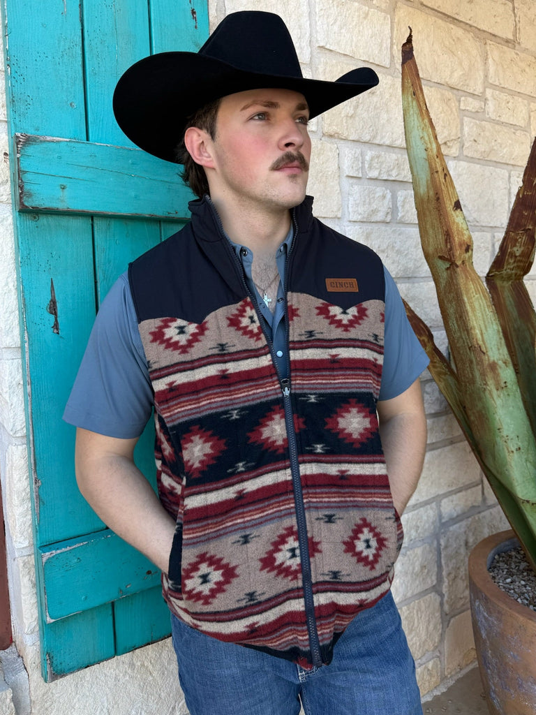 Men’s Cinch reversible western vest in navy and brown, features an Aztec fleece pattern and water-resistant tan quilted side, with lightweight insulation and dual hand pockets – MWV1576004. Available at Blair’s Western Wear, Marble Falls, TX.
