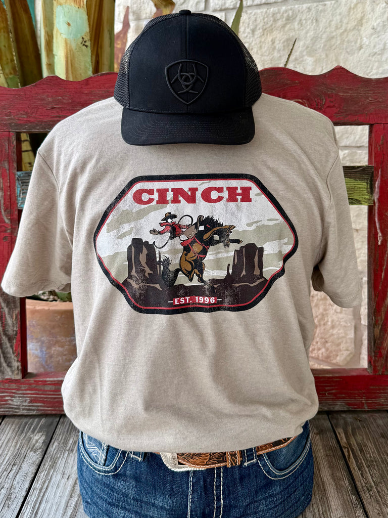 Men’s Cinch Short Sleeve Logo Bronc T-Shirt in Tan/Black, made from a soft cotton blend for comfort, with a bold bronc rider graphic for authentic western style - MTT1690662. Available at Blair's Western Wear, Marble Falls, TX.
