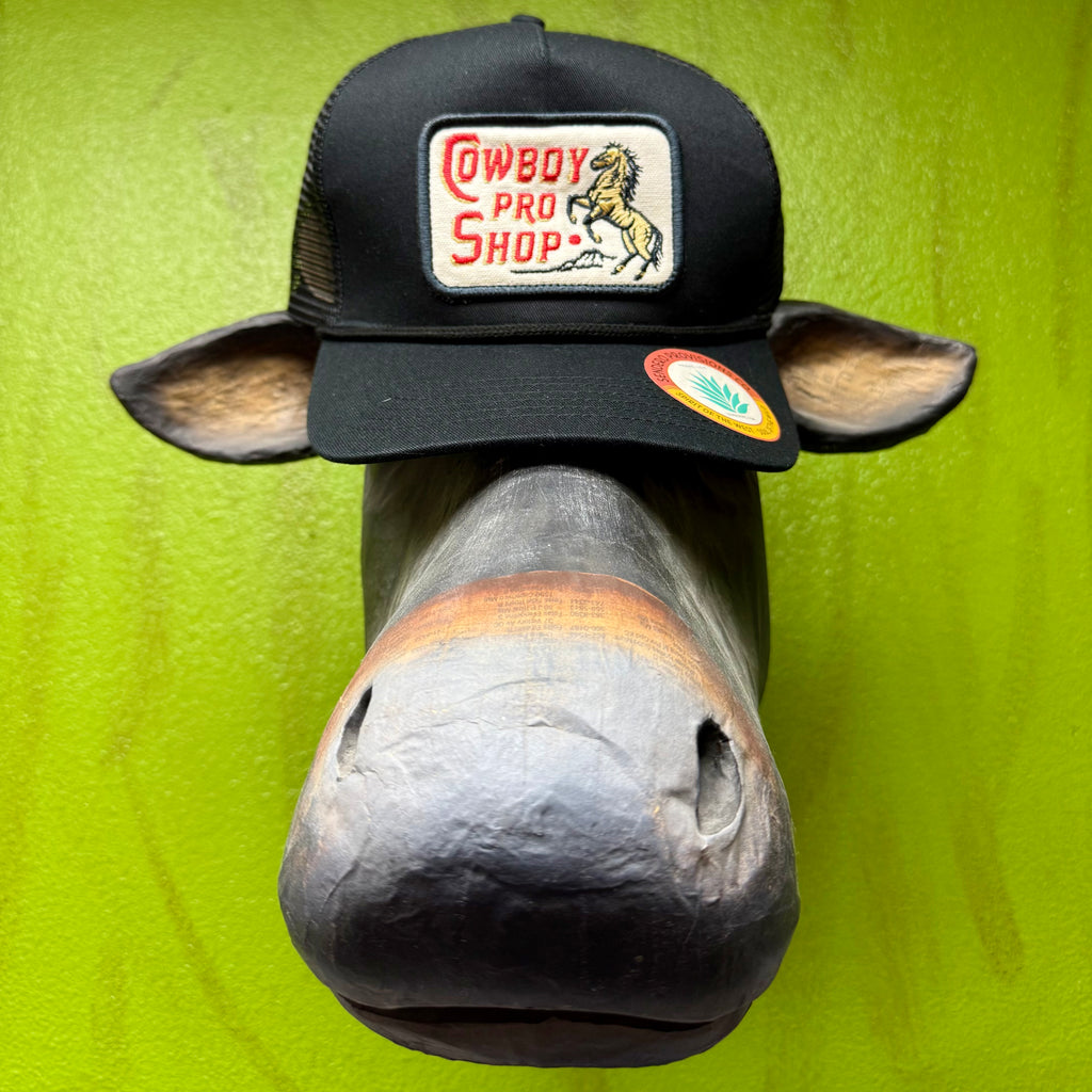Men's Cowboy Pro Shop Trucker Cap in Black, structured front panels that hold their shape, with breathable mesh back panels for airflow - PRO SHOP. Available at Blair's Western Wear, Marble Falls, TX.