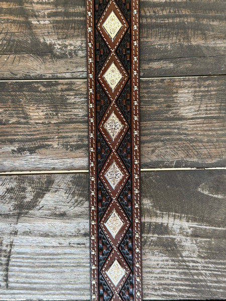 Dark chocolate basketweave tooled leather with diamond-shaped engraved silver conchos, silver dome studs along the edges, cream contrast stitching, and a large engraved silver western buckle — a premium, heavily detailed belt built for the man who doesn't do anything halfway.