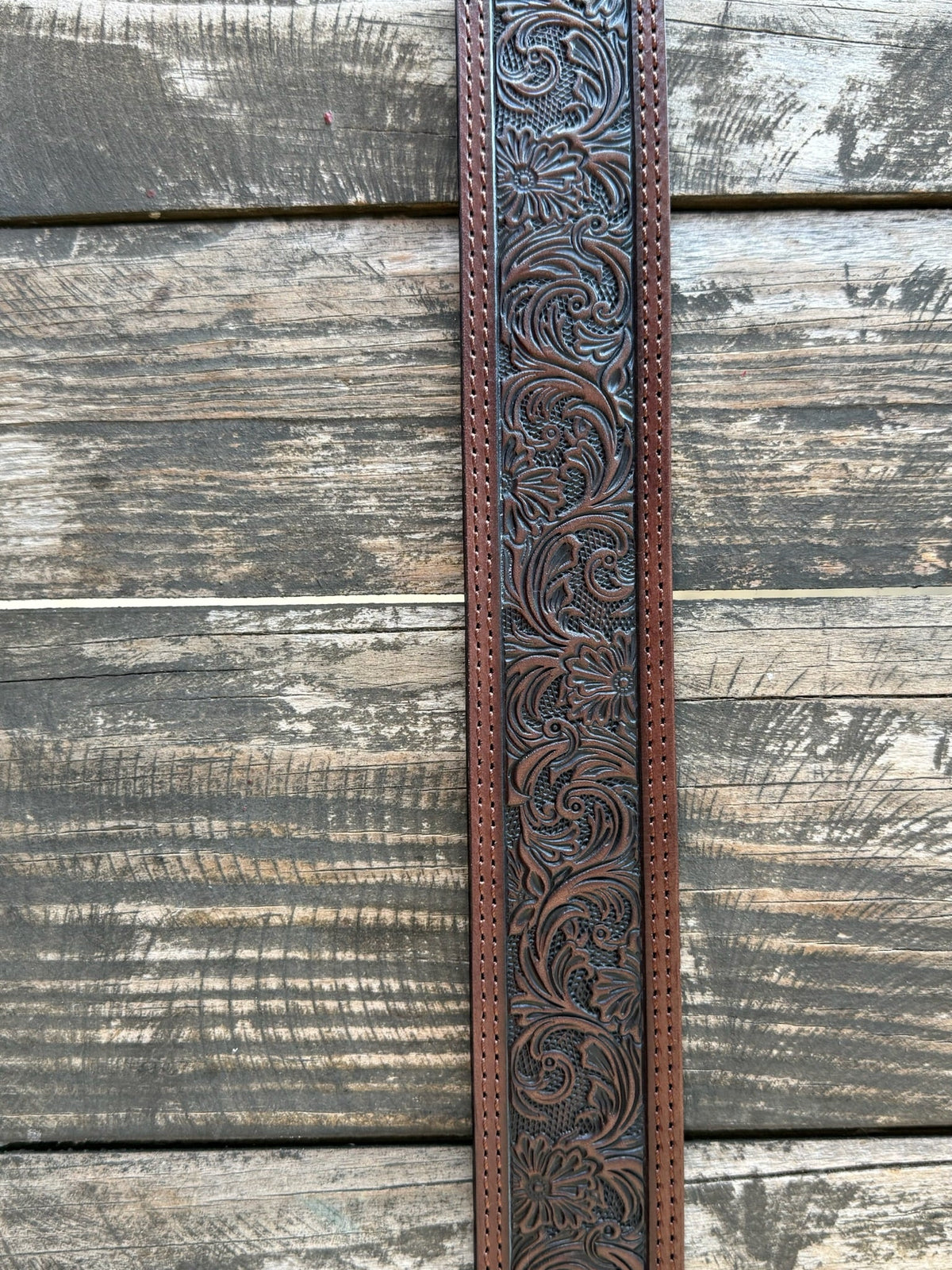 Dark chocolate leather with edge-to-edge floral scroll tooling and a large engraved silver western buckle — a timeless western belt with deep, handcrafted detail that speaks for itself. Clean lines, rich texture, and the kind of quality that gets better with every wear.