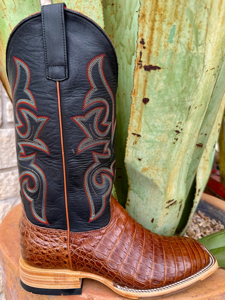 Men’s HP Top Hand Collection Western square toe caiman boot in brown, featuring genuine caiman leather foot with natural scale texture, with a black leather shaft and multicolor western stitching - HP8082. Available at Blair's Western Wear, Marble Falls, TX.