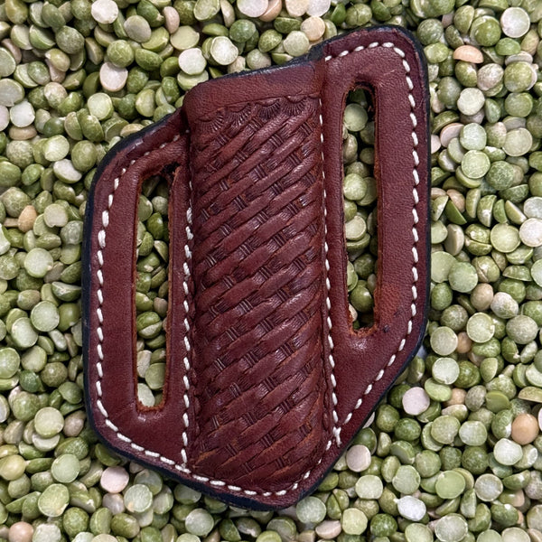 Men’s leather sheath in brown, rugged basket-weave texture with double belt slots and contoured shape for secure carry – IK10. Available at Blair's Western Wear, Marble Falls, TX.