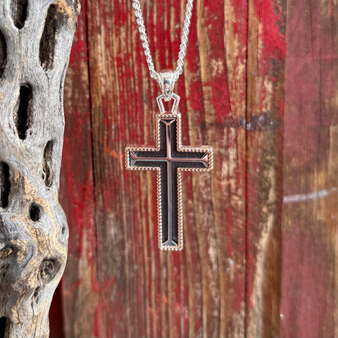 Men's Montana Silversmiths cross pendant necklace in black with a rose gold-tone rope border, dimensional beveled design, with protective finish to resist tarnish - NC6430. Available at Blair's Western Wear, Marble Falls, TX.
