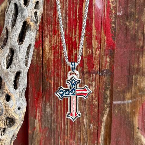 Men’s Montana Silversmiths necklace flag cross pendant in red, white, and blue, sculpted American flag enamel design with silver-plated engraved detailing - AMNC6174. Available at Blair's Western Wear, Marble Falls, TX.