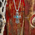 Men's Montana Silversmiths necklace silver cross with turquoise stone in silver, crafted in a detailed silver-tone cross design that delivers bold Western character, with intricate blackened scrollwork and geometric arrow-style detailing - NC6274. Available at Blair's Western Wear, Marble Falls, TX.