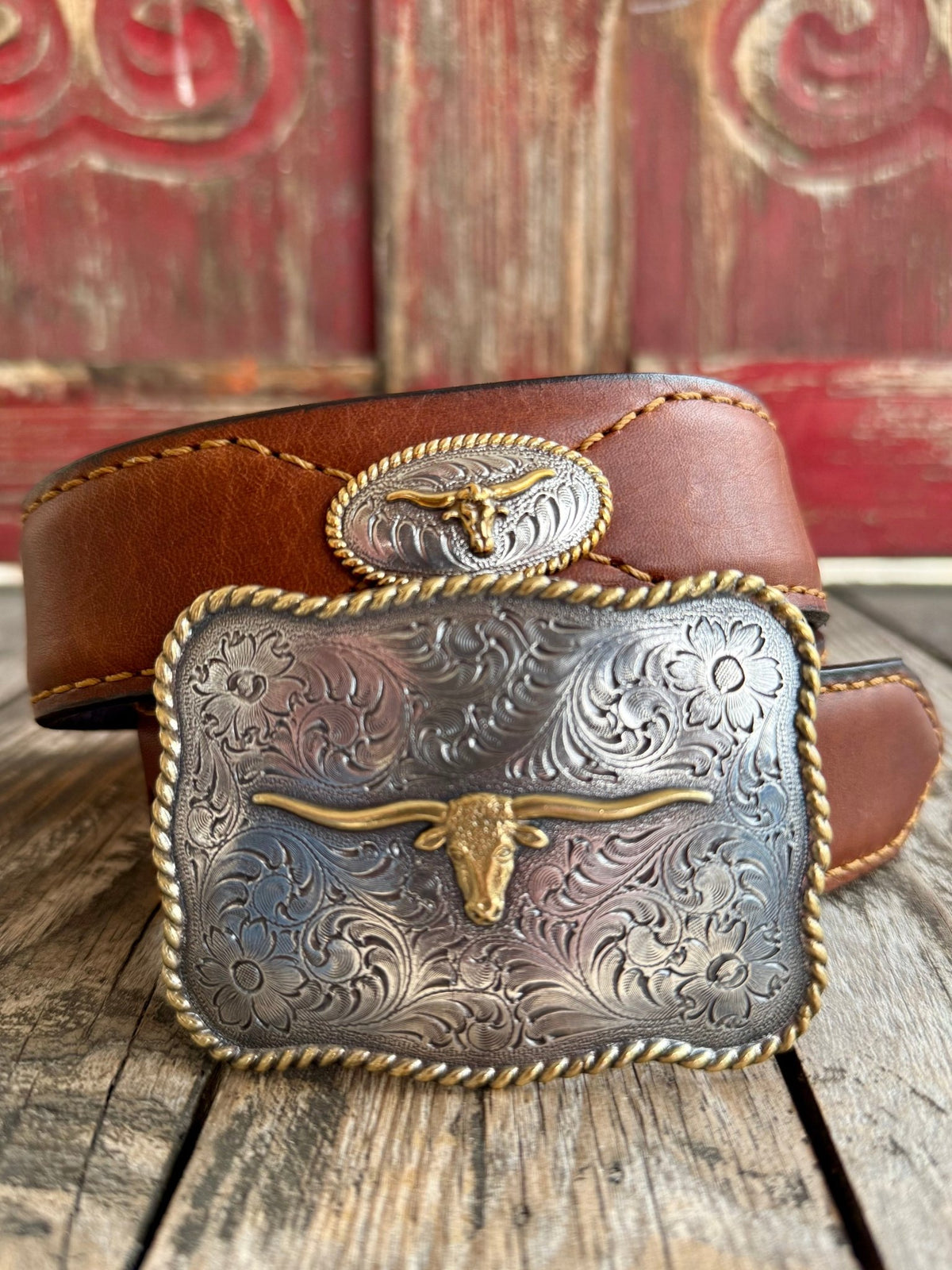 Men's Nocona Belt Western Longhorn Concho Belt in Brown, full-grain leather strap that molds comfortably with wear, with engraved floral buckle featuring raised gold longhorn centerpiece - VB8102. Available at Blair's Western Wear, Marble Falls, TX.