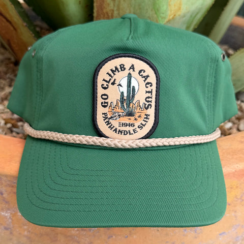 A green trucker-style cap with a beige rope detail across the front and a circular embroidered patch reading 'Go Climb a Cactus with Panhandle Slim 1946.' 