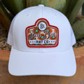 Men's White cap with aztec Red Dirt Hat Co. Logo at the front in the colors red-orange, brown , and turquoise  - it has a an adjustable snapback strap on the back for adjustable fit 