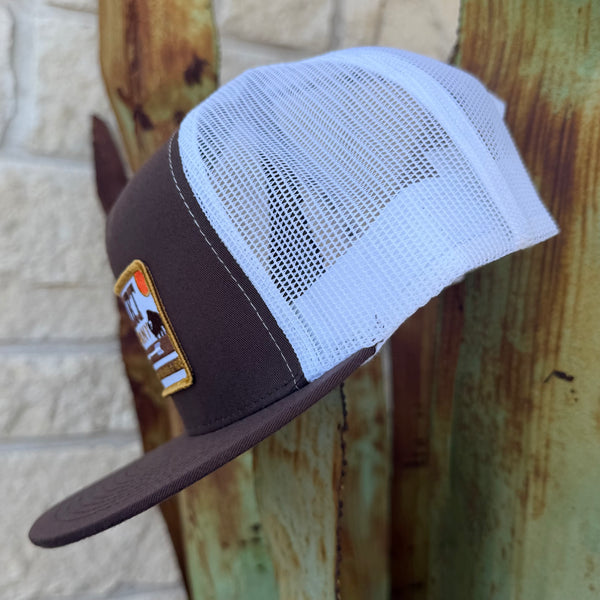 A brown and white trucker hat with a white mesh back and a brown visor, 
