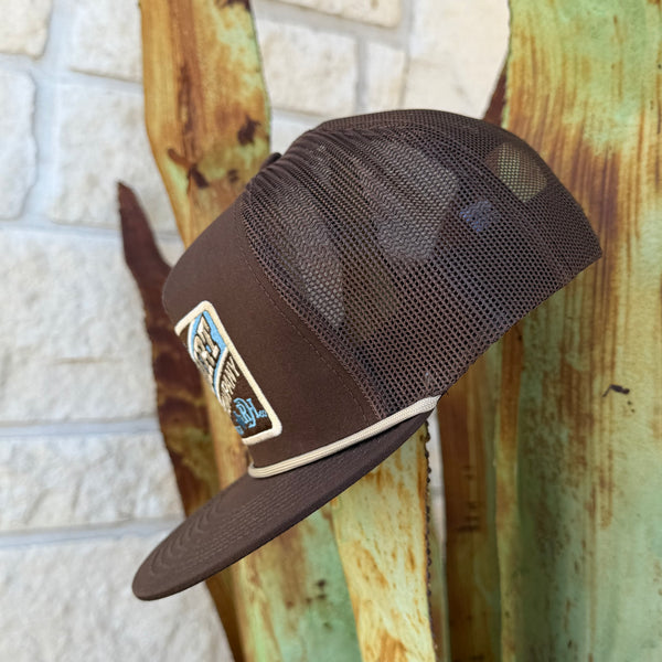A dark brown trucker cap with a mesh back and a rectangular embroidered patch on the front, 