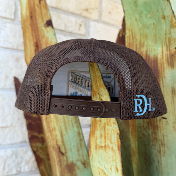 A brown mesh-back trucker cap shown from the back, featuring a brown plastic snap closure and a light blue embroidered 'RDH' logo on the side. 