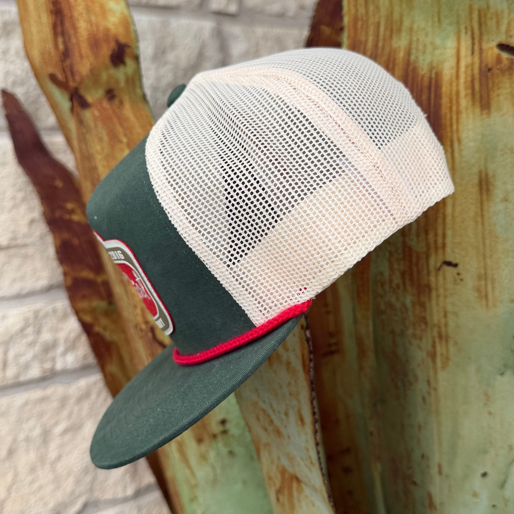 A dark green and off-white mesh trucker hat with a red accent stripe and a small embroidered patch on the brim