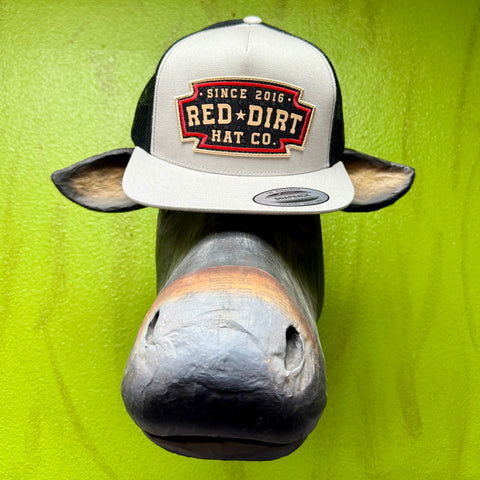 Men’s Red Dirt Hat Co. mesh cap in silver and black, structured silver front with embroidered Red Dirt patch, and breathable black mesh back – RDHC540. Available at Blair's Western Wear, Marble Falls, TX.