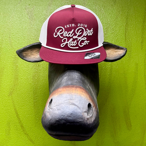 Men’s Red Dirt Hat Co. mesh trucker cap in burgundy and white, with raised embroidered logo and contrast rope detail – RDHC521. Available at Blair’s Western Wear, Marble Falls, TX.