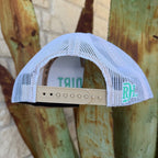A white mesh back trucker hat shown from the back,The hat features a beige adjustable strap and a mint green circular 'RDH' logo on the side.