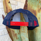 This Red Dirt Hat Co. trucker keeps it classic with a structured navy front, breathable mesh back, and a bold embroidered patch that does all the talking. The red rope accent cord along the brim adds just enough detail to set it apart from every other cap on the rack.