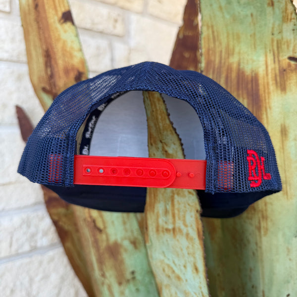 This Red Dirt Hat Co. trucker keeps it classic with a structured navy front, breathable mesh back, and a bold embroidered patch that does all the talking. The red rope accent cord along the brim adds just enough detail to set it apart from every other cap on the rack.