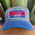 A trucker-style cap with a gray front panel, blue brim and mesh side panels, and a large front patch reading 'RODEO TIME' in red with 'DALE BRISBY' below it