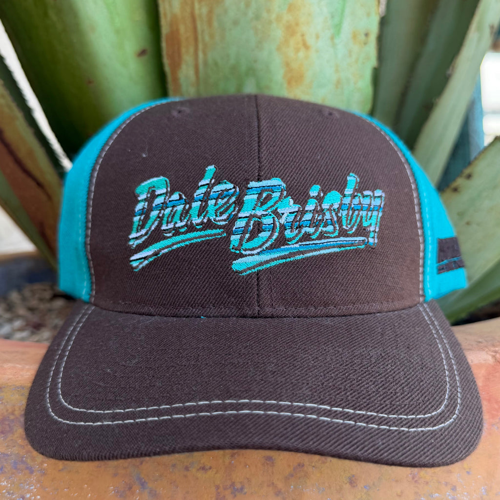 A brown and teal trucker hat with 'Dale Brisby' embroidered on the front,background.