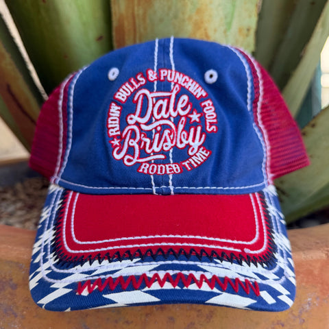 A blue, red, and white embroidered trucker hat with a patriotic western theme, featuring 'Ridin Bulls & Punchin Fools' and 'Dale Brisley' embroidered