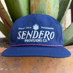 A navy blue cap with 'SENDERO PROVISIONS CO.' embroidered in white on the front with a red & blue rope sitting on the brim 