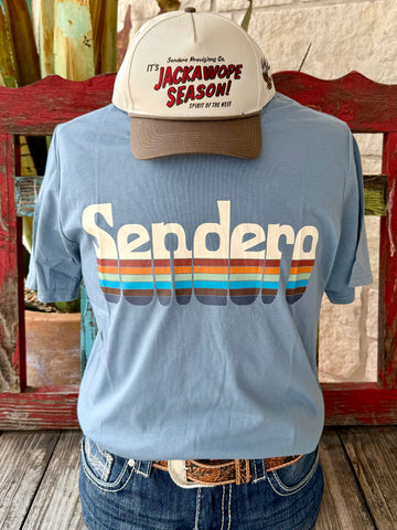 Men’s Sendero Provisions Co. graphic short sleeve t-shirt in light blue with multi-color retro stripe logo, made with a soft cotton blend, and featuring durable print that resists fading - SPCS125S28. Available at Blair's Western Wear, Marble Falls, TX.