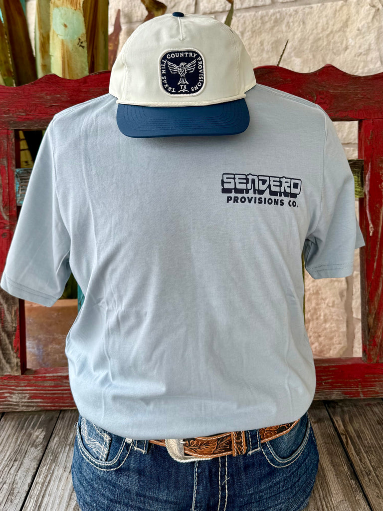 Men’s Sendero Provisions graphic short sleeve t-shirt in light blue with peach accents, soft breathable cotton blend, bold cowboy and samurai skeleton “Dust and Bones” back graphic, and durable construction - SPCS125F16. Available at Blair's Western Wear, Marble Falls, TX.