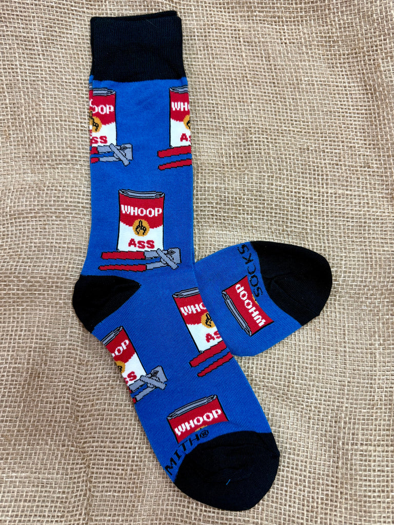 Men’s Socksmith novelty crew socks in blue, featuring a “Can of Whoop Ass” design, with reinforced heel and toe, and soft cotton-blend comfort - MNC3038. Available at Blair's Western Wear, Marble Falls, TX.