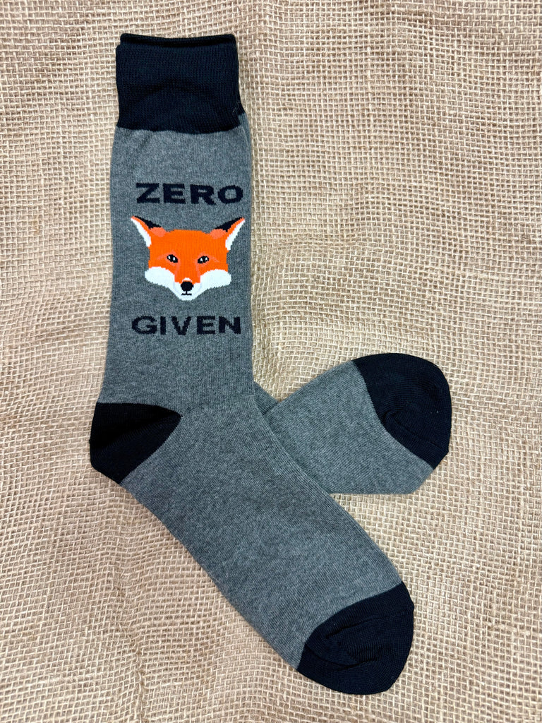 Men’s Socksmith novelty crew socks in gray heather with orange fox design and “Zero Fox Given” text, crafted from a soft cotton blend for comfort, with reinforced heel and toe for durability - MNC684. Available at Blair's Western Wear, Marble Falls, TX.