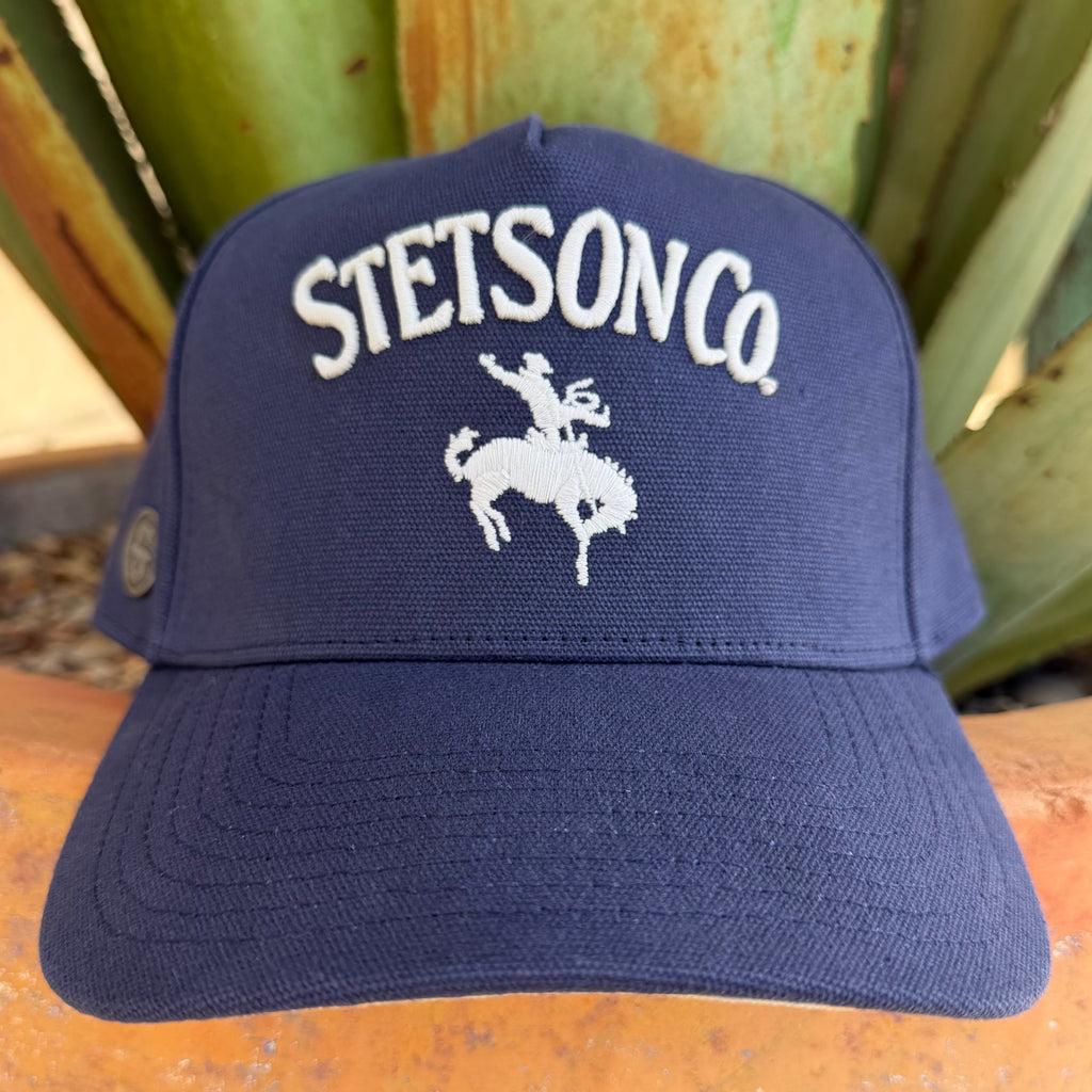 A navy blue Stetson Co. cap with a white embroidered logo and rider graphic on the front, 