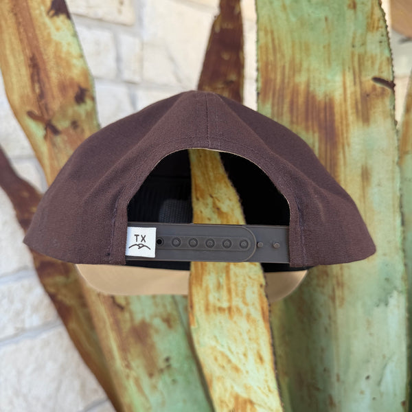 A dark brown baseball cap shown from the back, featuring a brown adjustable strap with a white 'TX' logo patch, 