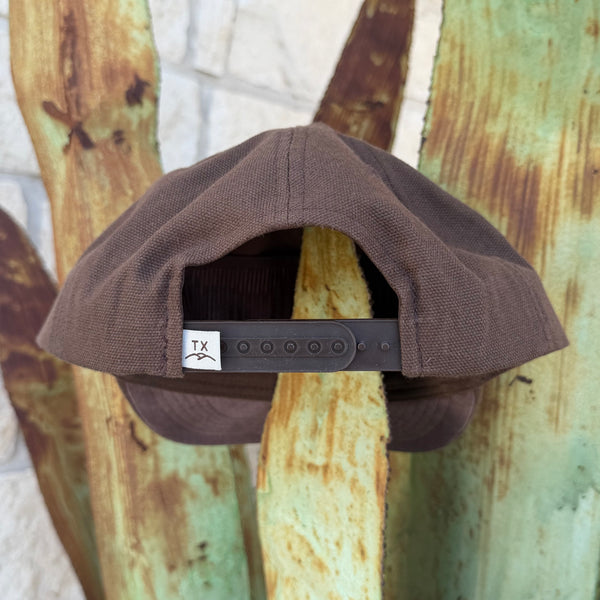 A brown structured snapback cap shown from the back. The back strap has a small white square patch with a black 'TX' logo.