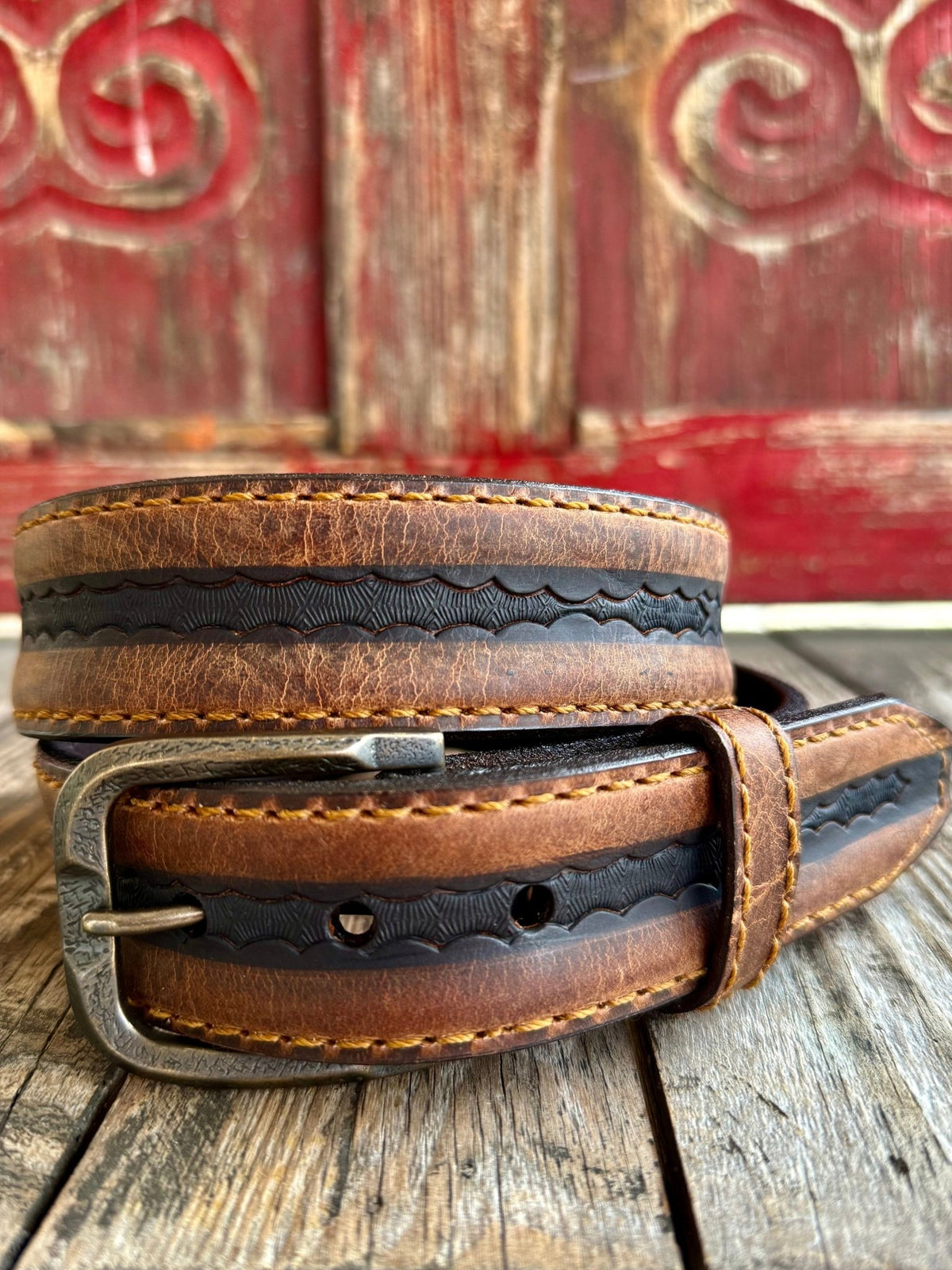 Men's Vintage Bison leather belt in honey and black, crafted from premium bison leather that offers exceptional durability while remaining flexible, with detailed scalloped edge tooling along the center strip - VB64063. Available at Blair's Western Wear, Marble Falls, TX.