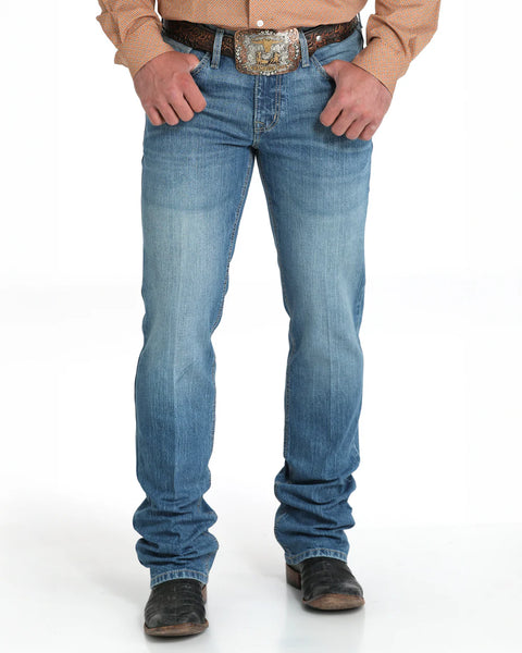 The Cinch Ian Slim Fit Jean offers a sleek, comfortable look with its mid-rise and slim fit through the seat, thigh, and knee. Made with stretch denim for easy movement and finished in a medium stonewash with subtle sanding, it pairs a modern style with classic five-pocket details and a boot-friendly leg opening. Men's Ian Slim Fit Jean - MB31836001. Available at BLAIR'S Western Wear located in Marble Falls TX.
