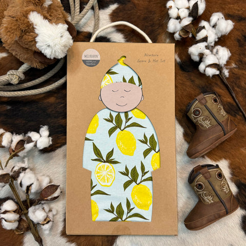 Milkbarn Newborn Gown & Hat Set that is light blue with a lemon pattern; the material it is made of is rayon from bamboo- 71089 - Available at BLAIR'S Western Wear located in Marble Falls TX