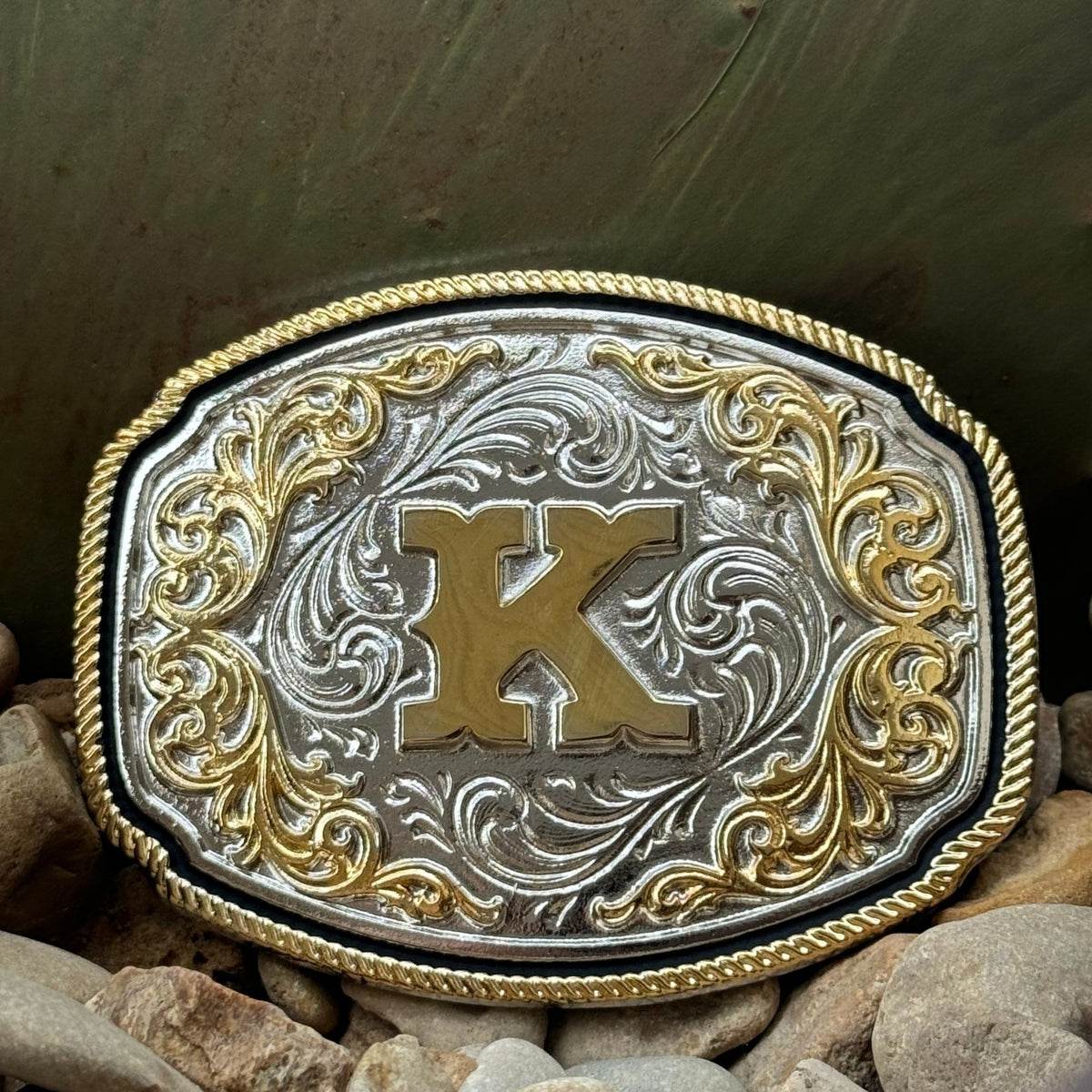 Montana Silversmiths Western Belt Buckle in silver and gold, featuring intricate engravings and a prominent 'K' initial - A1047K. Available at Blair's Western Wear, Marble Falls, TX.
